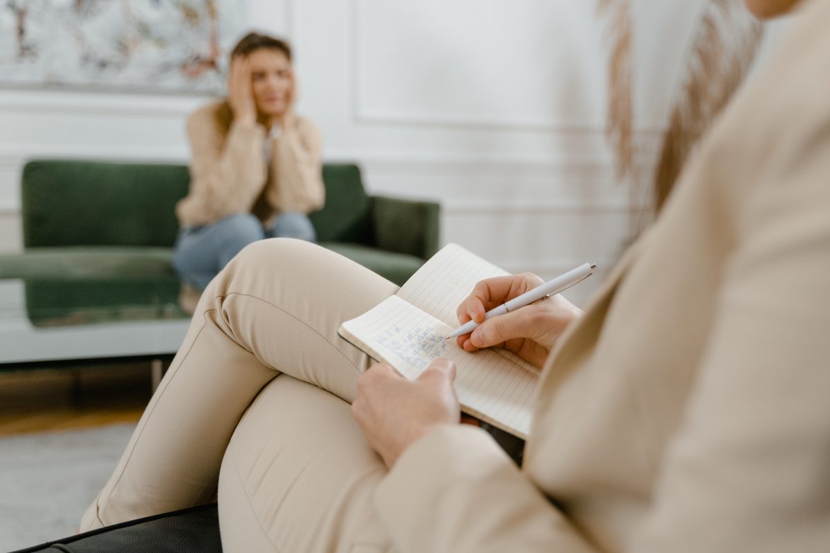 Therapist creating a handwritten progress note while in session