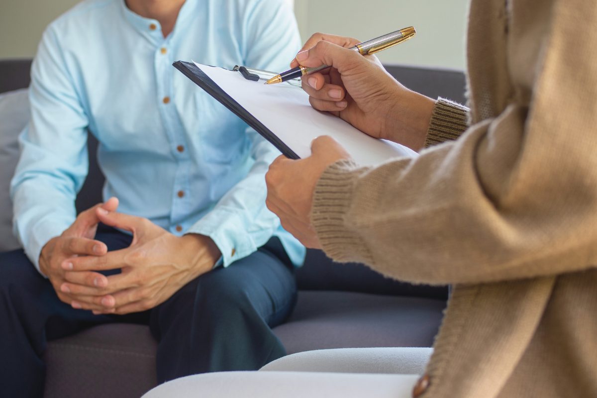 a counselor taking notes during a client session