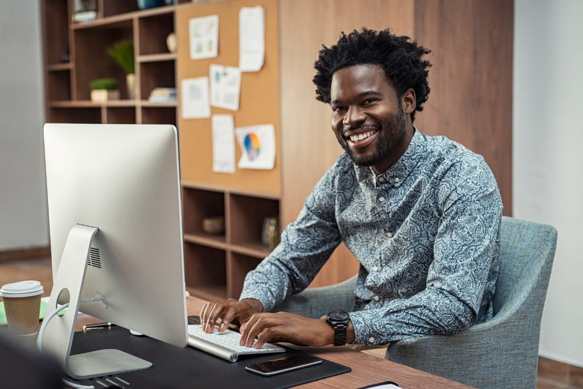 African american therapist writing a BIRP note on a computer workstation