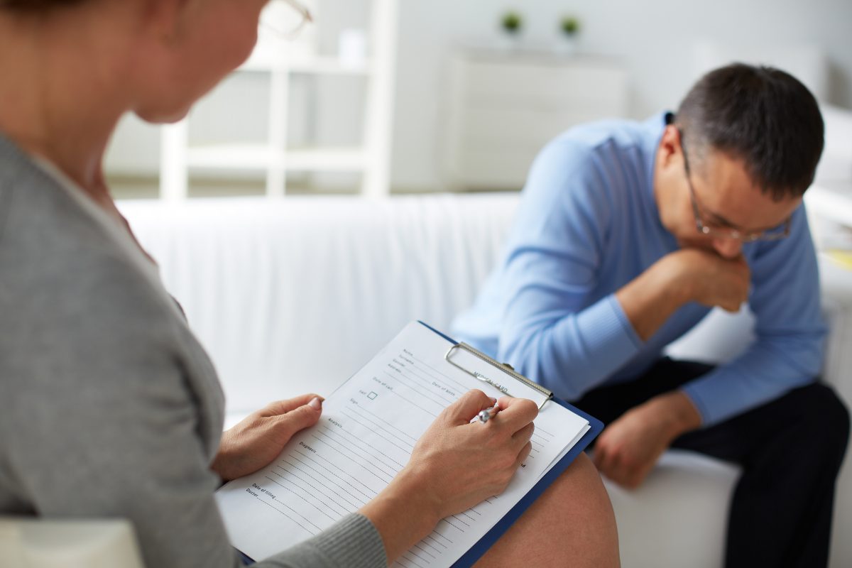 A mental health provider performing a therapy intake session with a client.