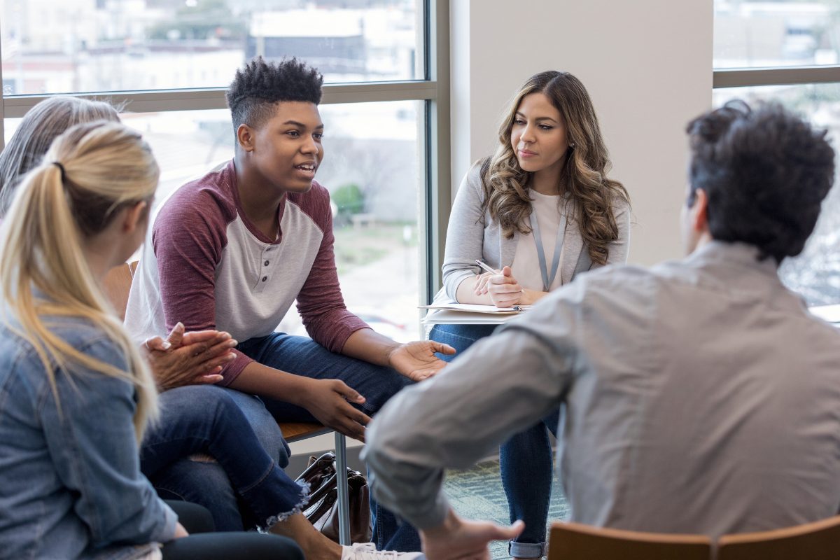 Group therapy participants navigating conflict resolution
