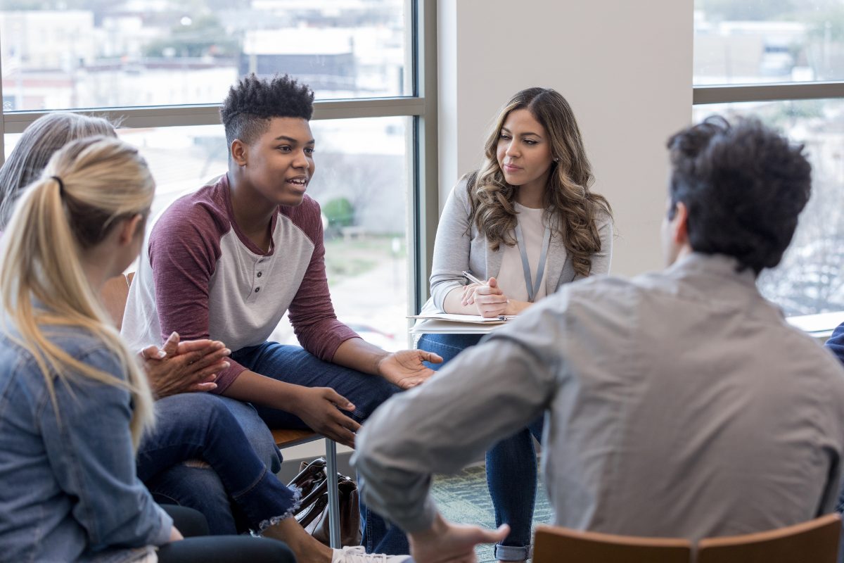 A group therapy session led by a mental health professional