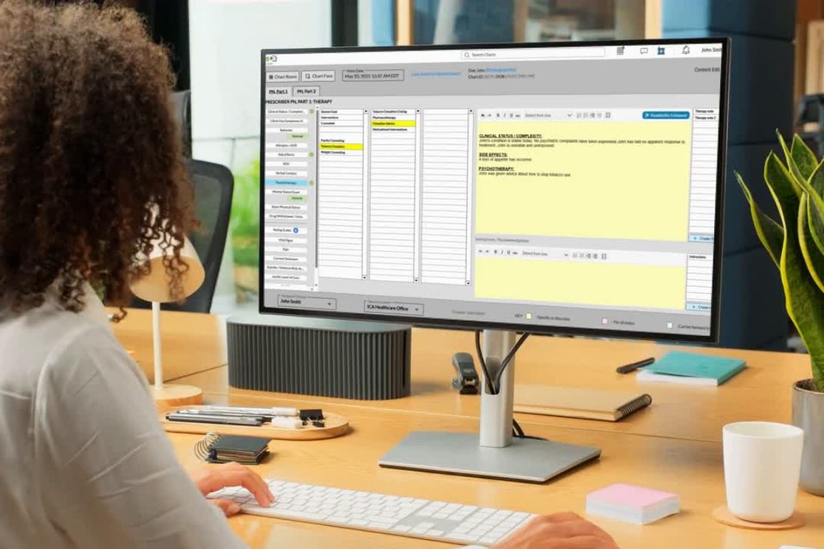 Therapist documenting a client session on a laptop, symbolizing the golden thread in mental health documentation that links assessment, treatment planning, and progress notes.